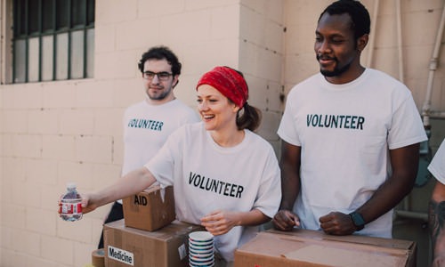 volunteers hand out bottles of water