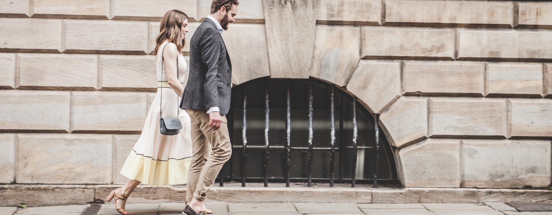 couple walking down the sidewalk holding hands