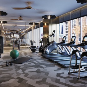 weight training and cardio equipment in bright, naturally lit fitness center