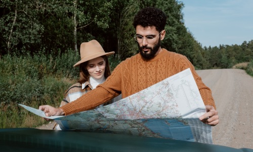 Couple looking at a map on the side of a road